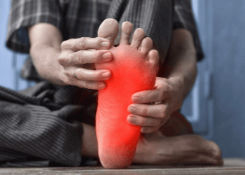 Man with Plantar fasciitis holding his foot 